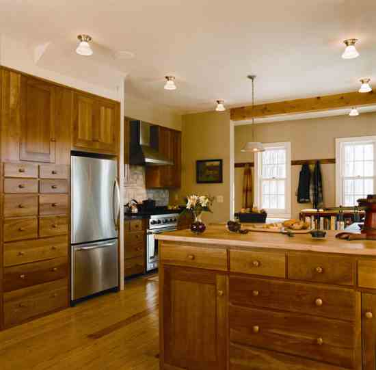 Fusing Shaker-style woodwork with sleek, stainless-steel appliances, the kitchen is uncluttered and elegant. “We prefer to keep it simple and healthy—without lots of gadgets or electronic devices,” Cathy says. “We have just three appliances: the refrigerator, stove and dishwasher—no microwave, toaster oven or coffee maker.” The wood countertop is from a maple felled during construction. “We decided to have it milled for sentimental reasons,” Michele says. “It’s nice to know the tree lives on in our home.”